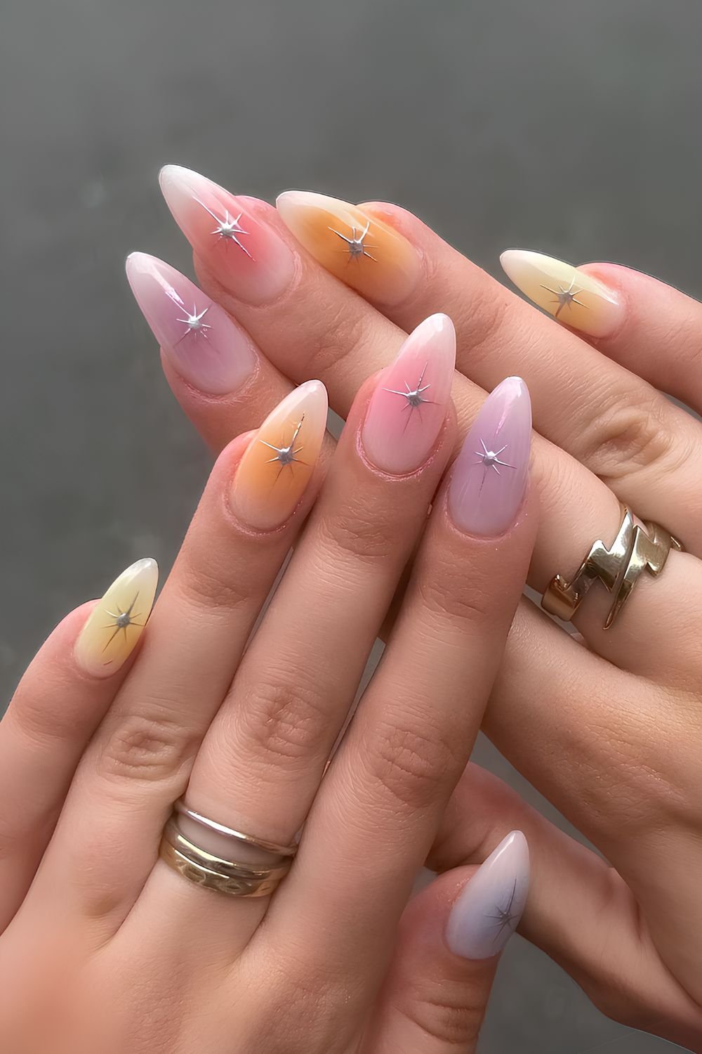 Colorful pastel aura nails with star accents