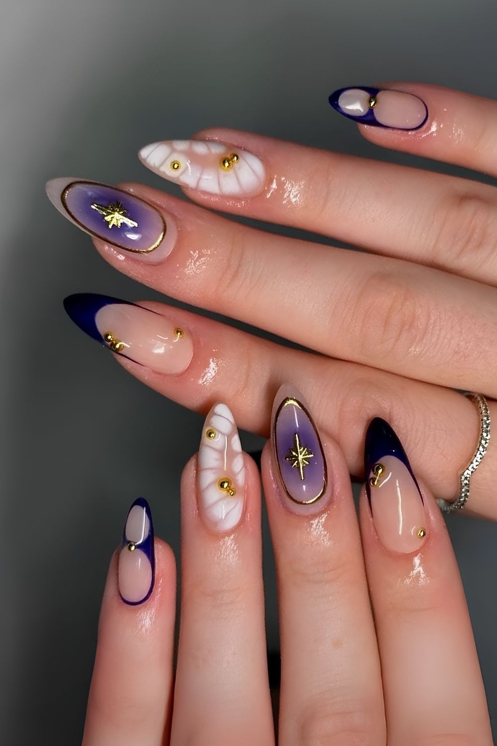 Dark blue and white nails with animal print and gold details