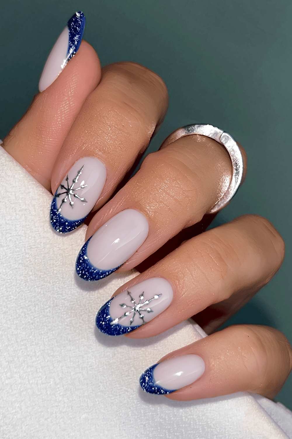 Dark blue glitter French nails with snowflakes