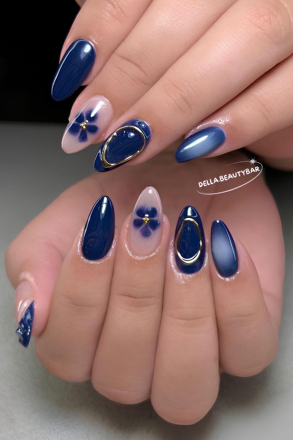 Dark blue mani with blooming flower and aura details