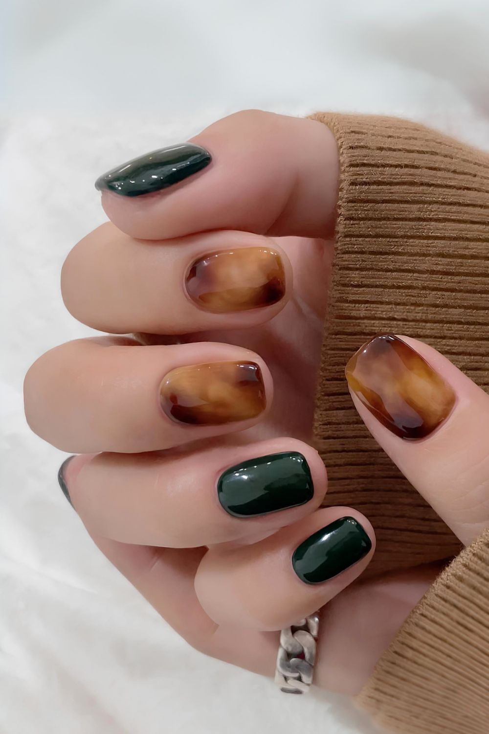 Dark green mani with tortie shell marble accent