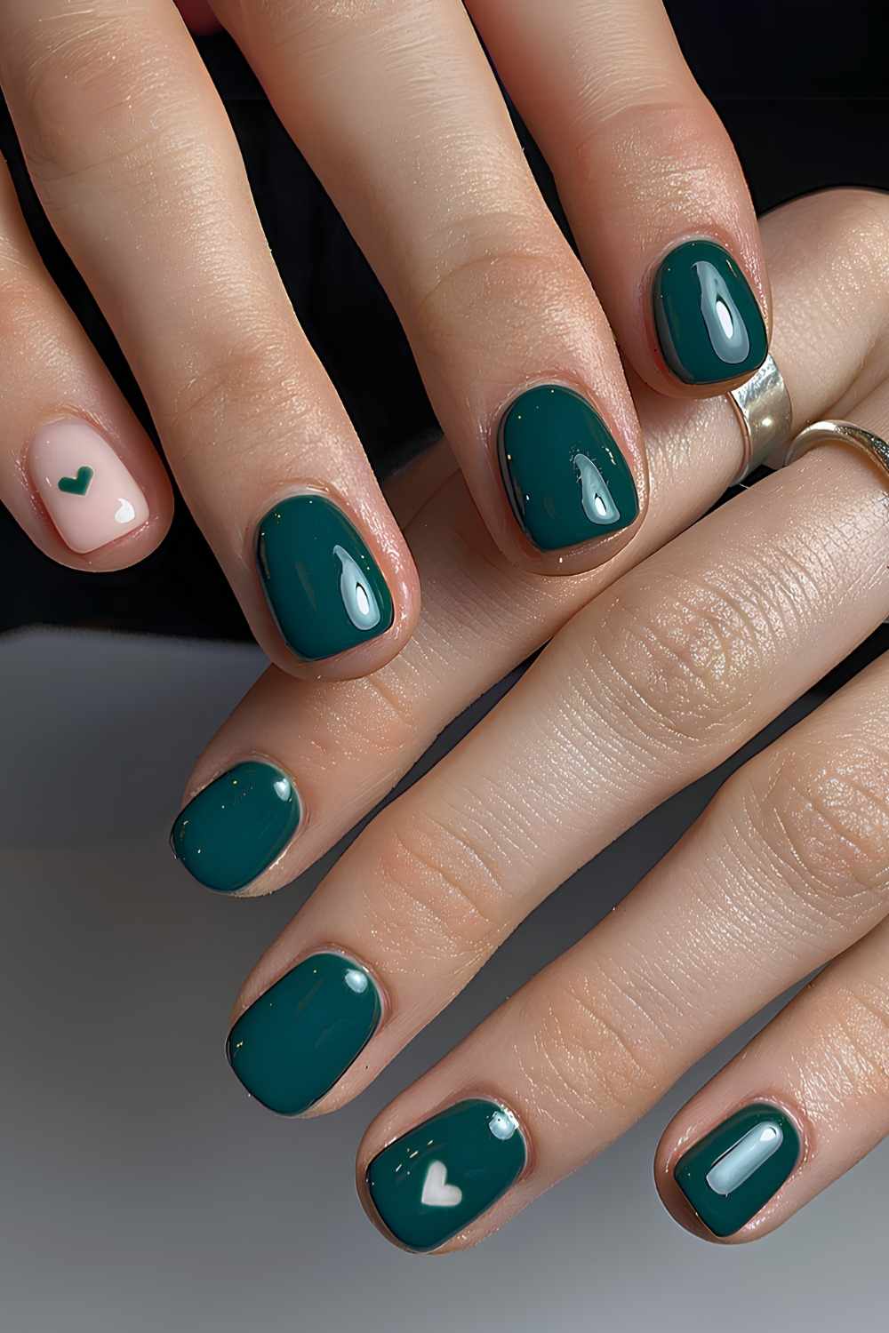 Dark green nails with heart art