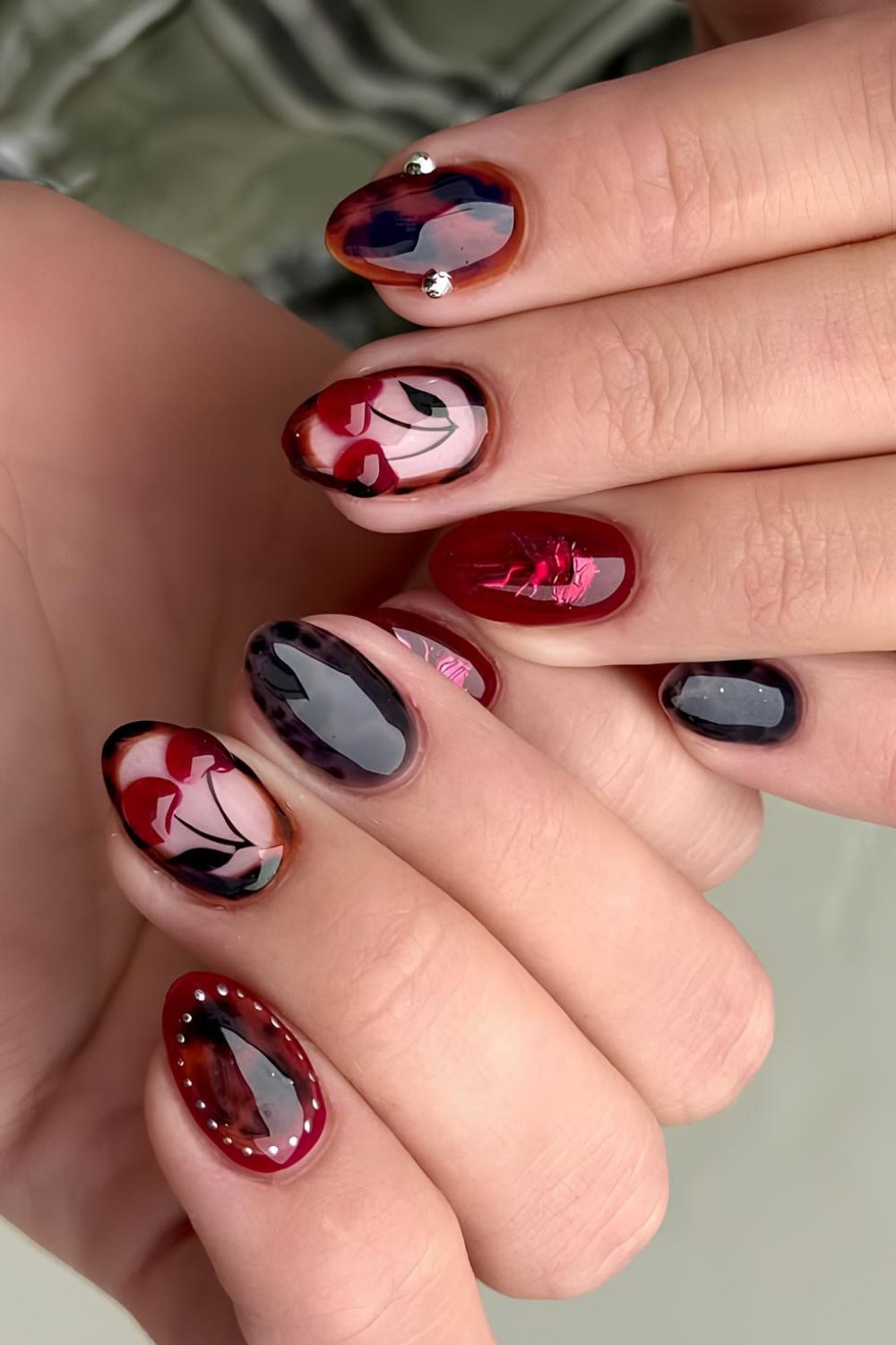 Dark red and tortoise nails with cherry accents
