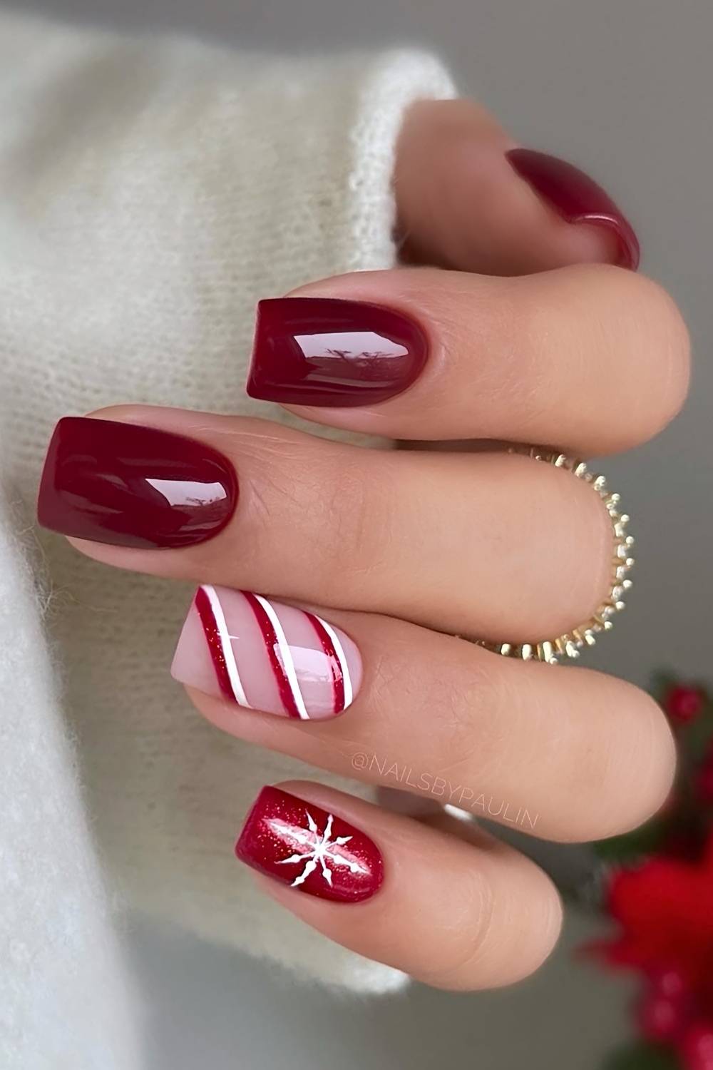Dark red nails with stripes and snowflakes