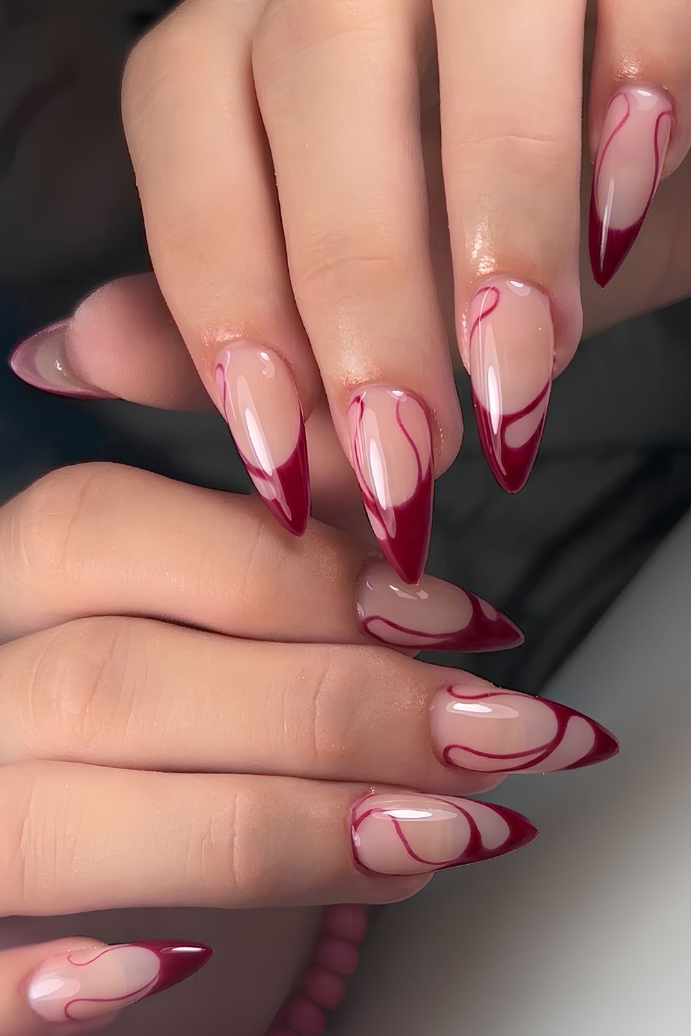 Dark red swirly French manicure