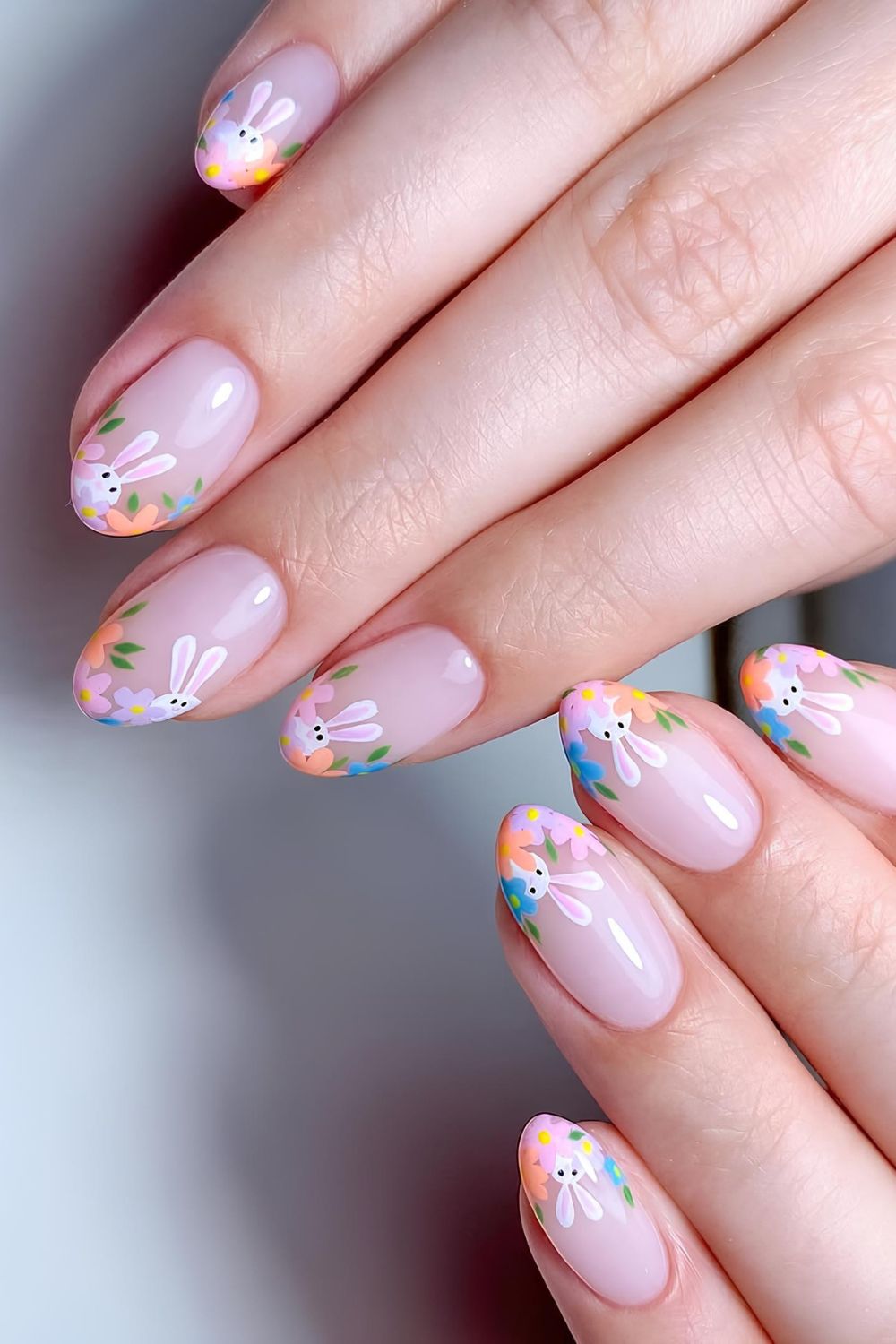 Floral French tip nails with peeking bunnies
