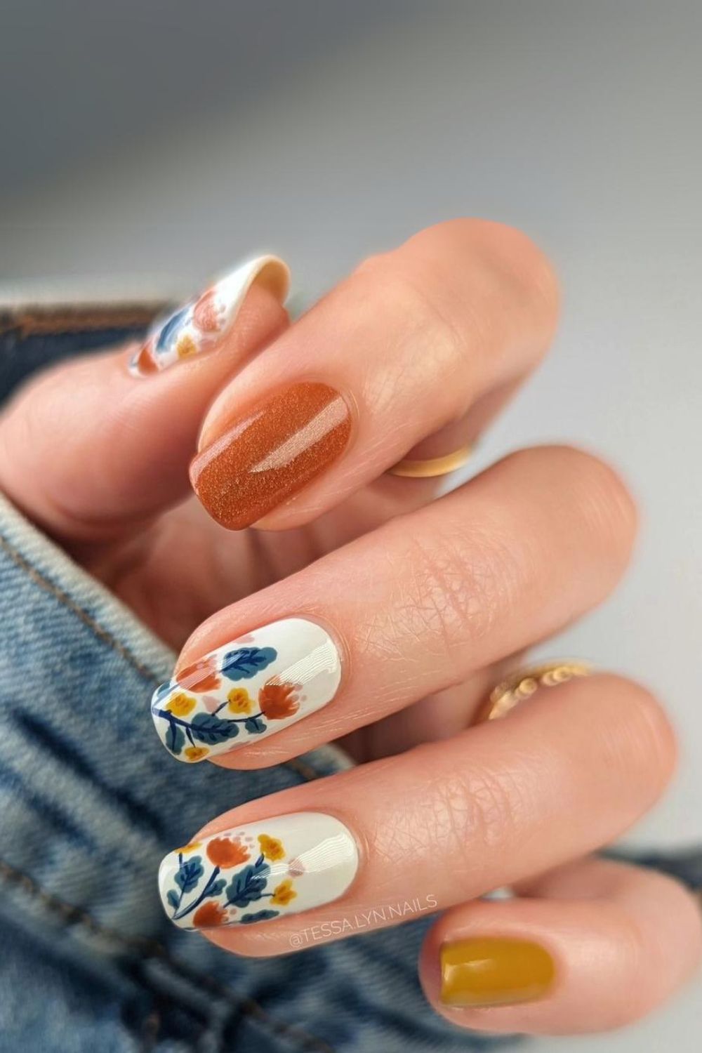 Flower-decorated white and mustard nails