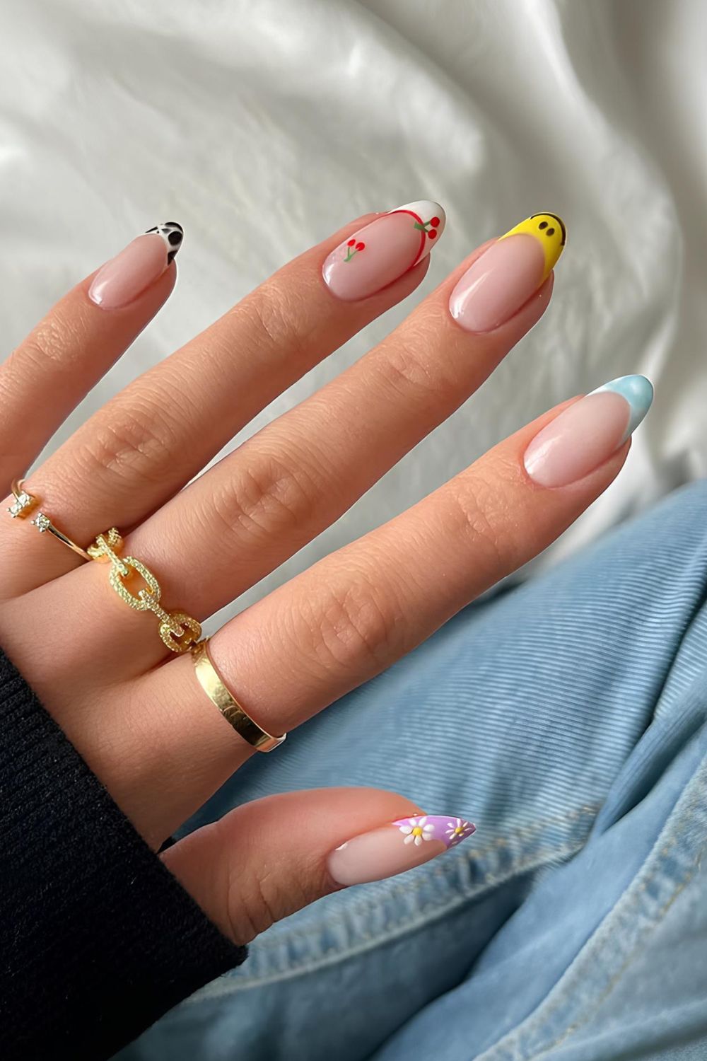 French nails with mixed designs on each finger