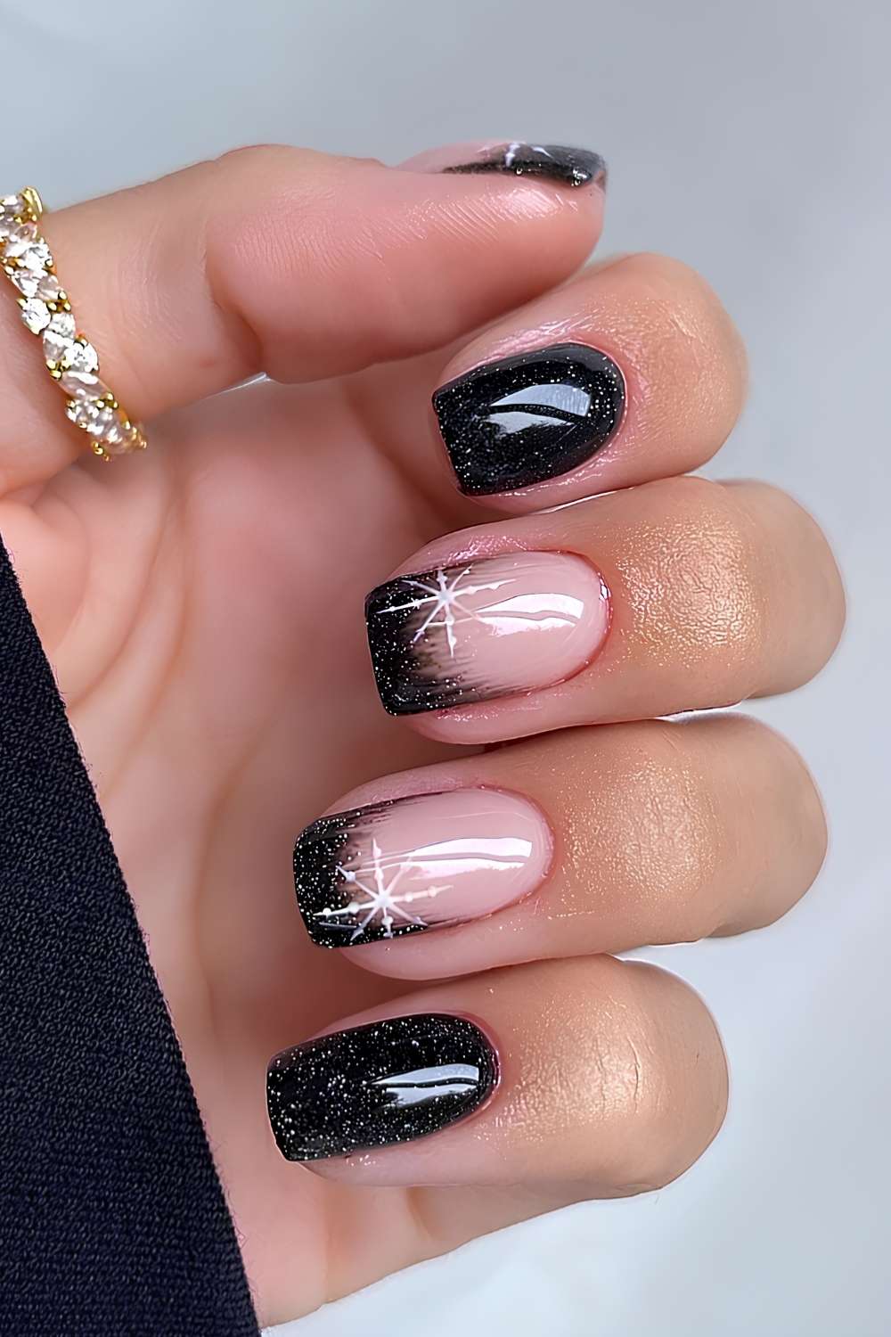 Glittery black nails with accent ombre and snowflakes