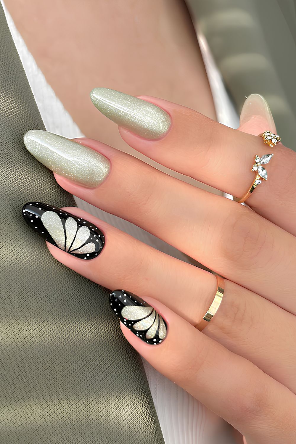 Glittery green nails with butterfly art