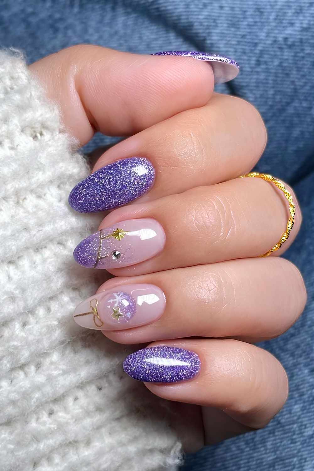 Glittery purple Christmas nails with gold accents
