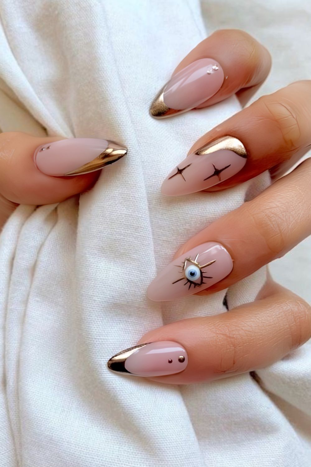 Gold chrome French tips with evil eye nail design
