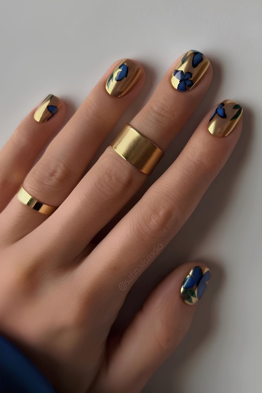 Gold nails with blue butterfly details