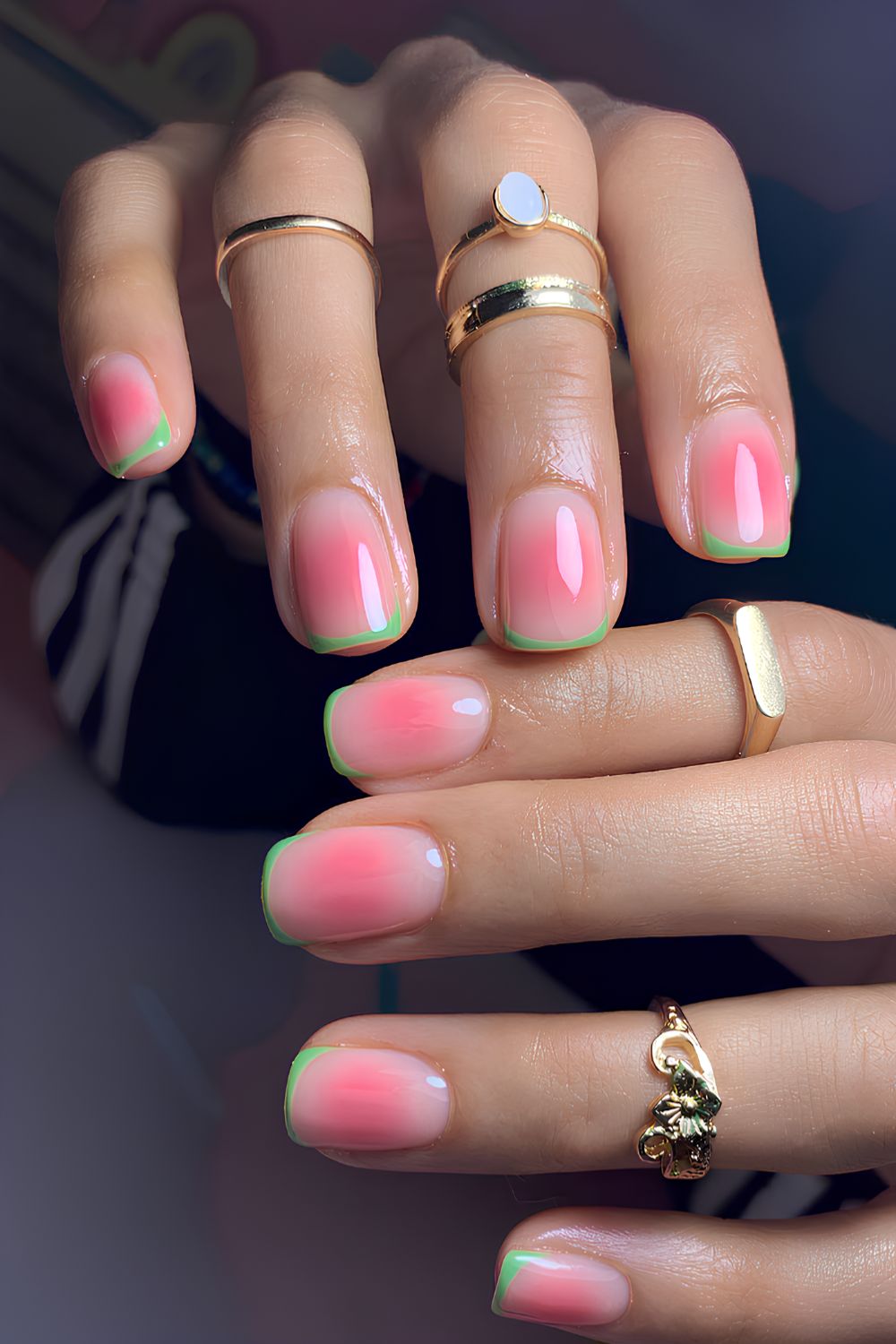 Green French nails on a pink aura base