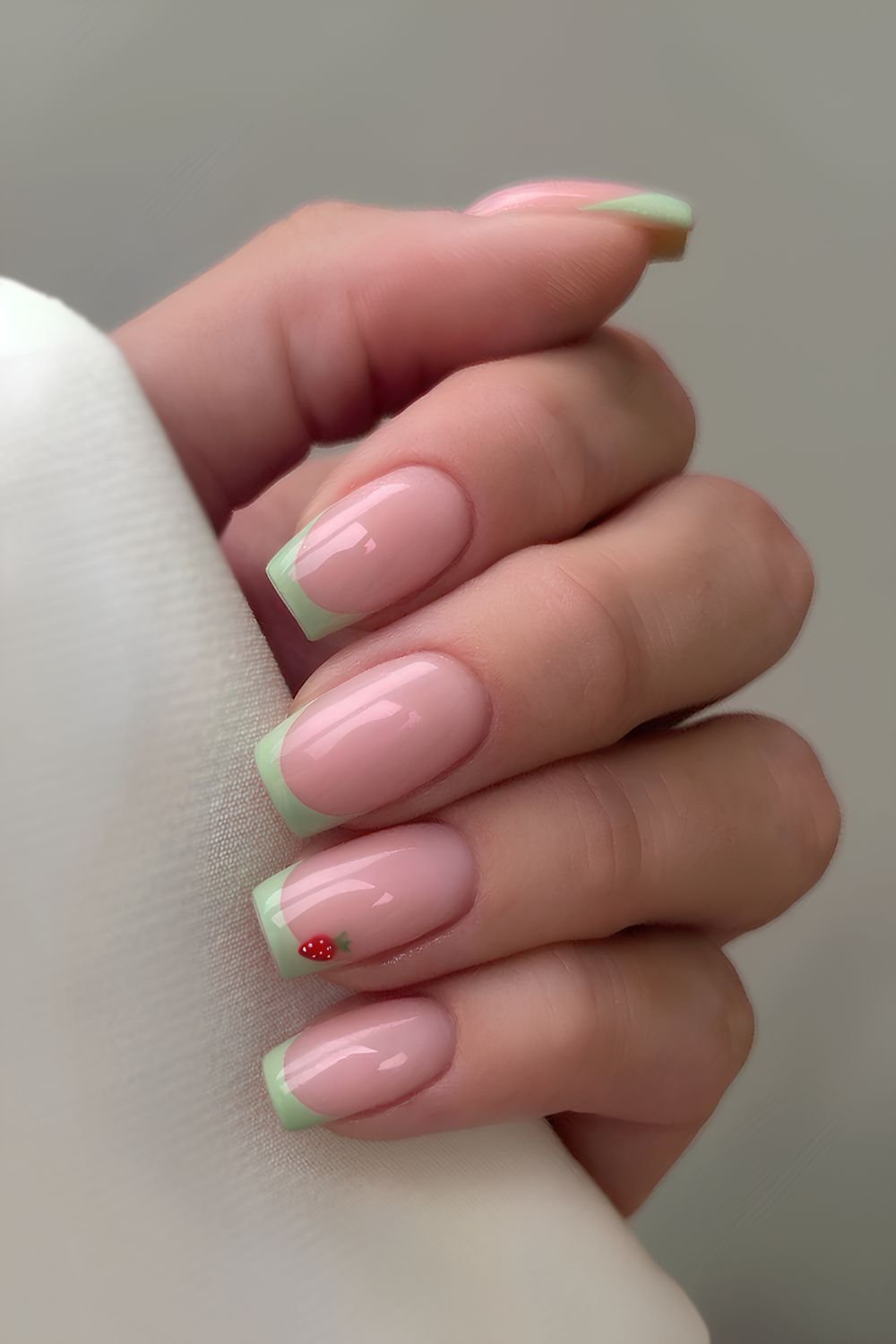 Green French nails with strawberry art