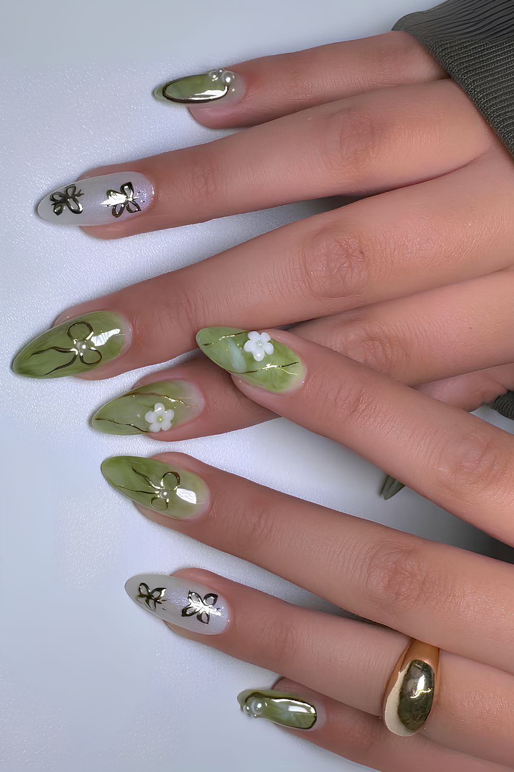Green and white nails with bows and butterflies
