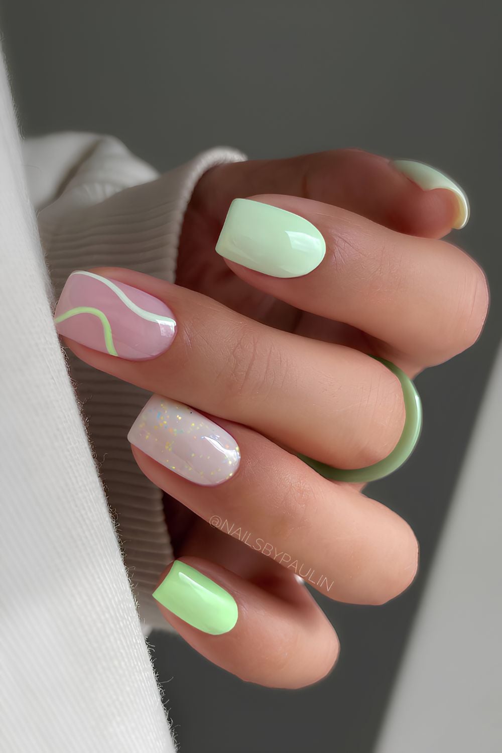 Green nails with glitter and swirls