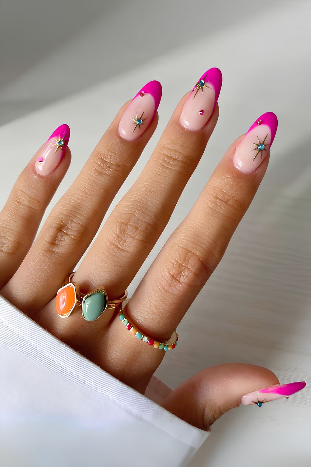 Hot pink French nails with celestial accents