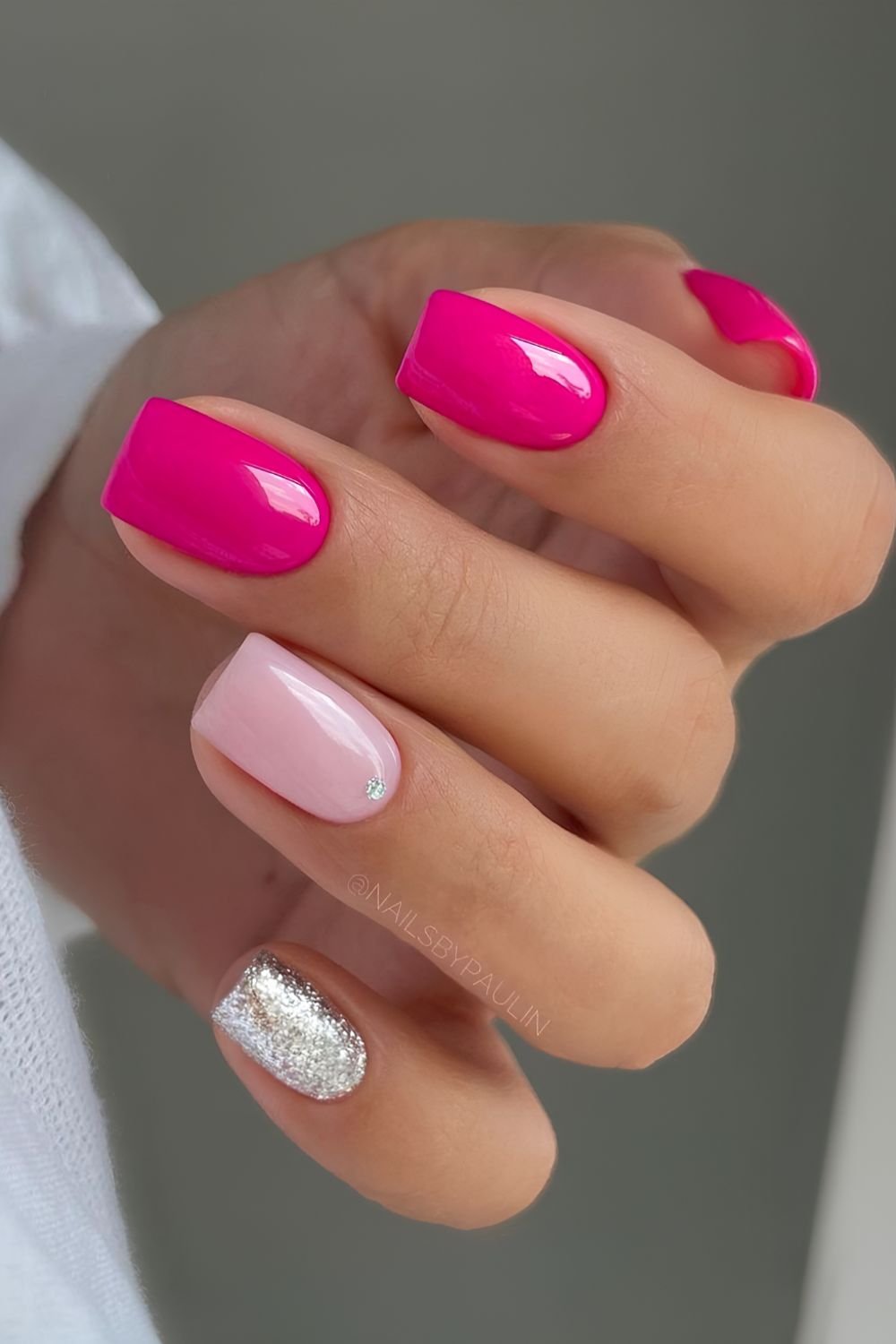Hot pink nails with silver glitter detail