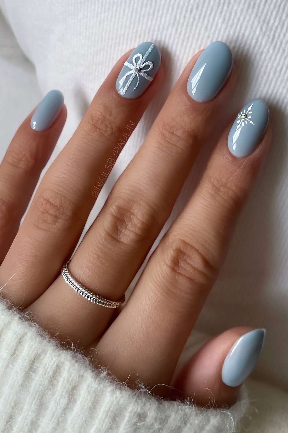 Icy blue nails with gift bow art accents