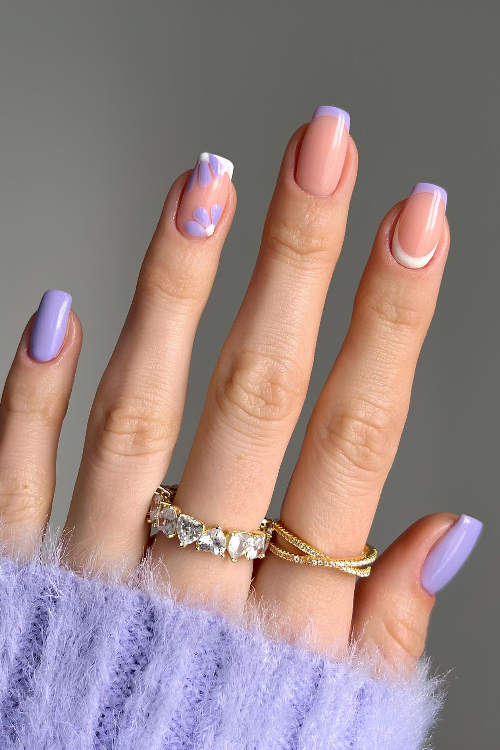 Lavender nails with floral accent and reverse French tip accent