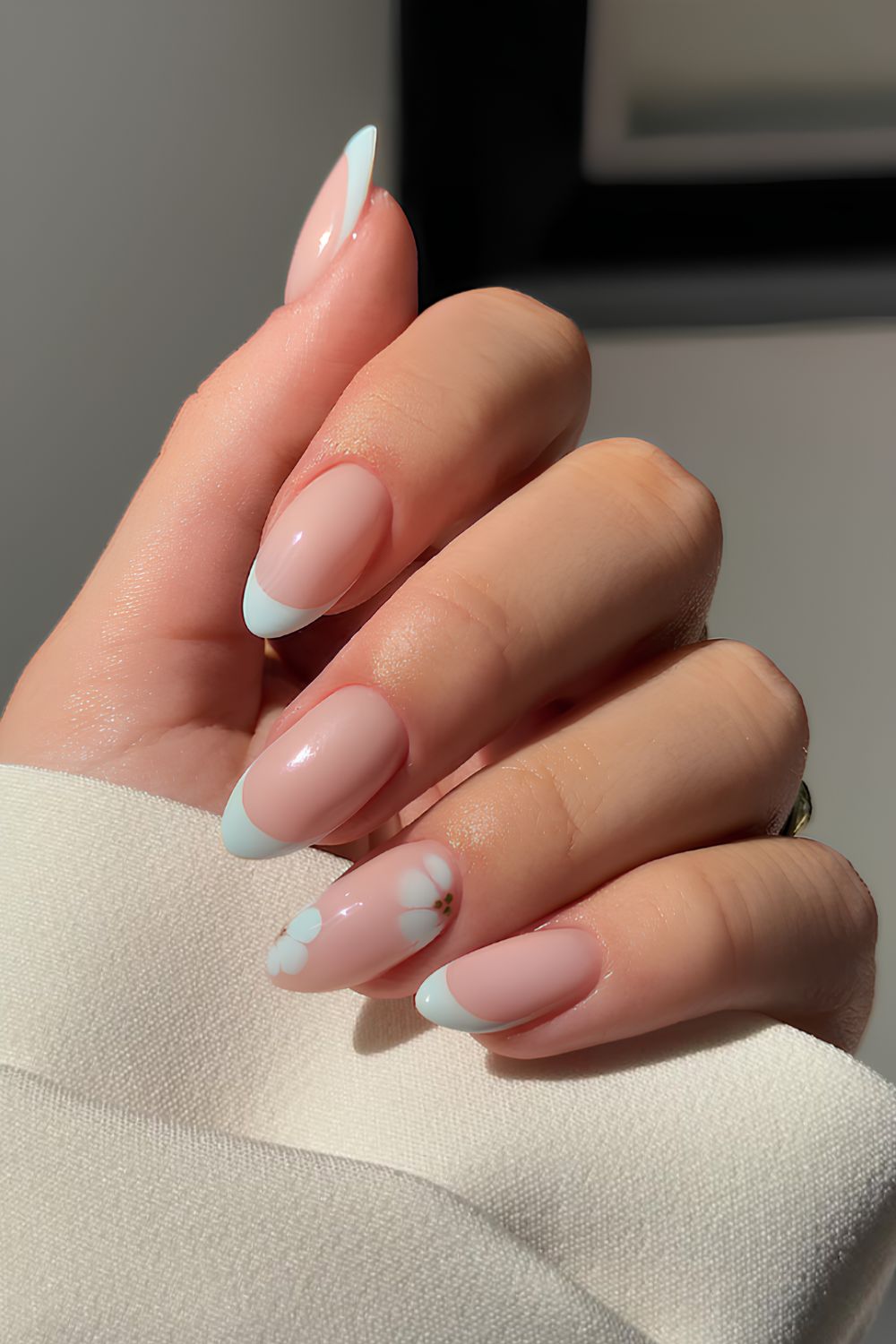 Light blue French mani with blooming gel flowers