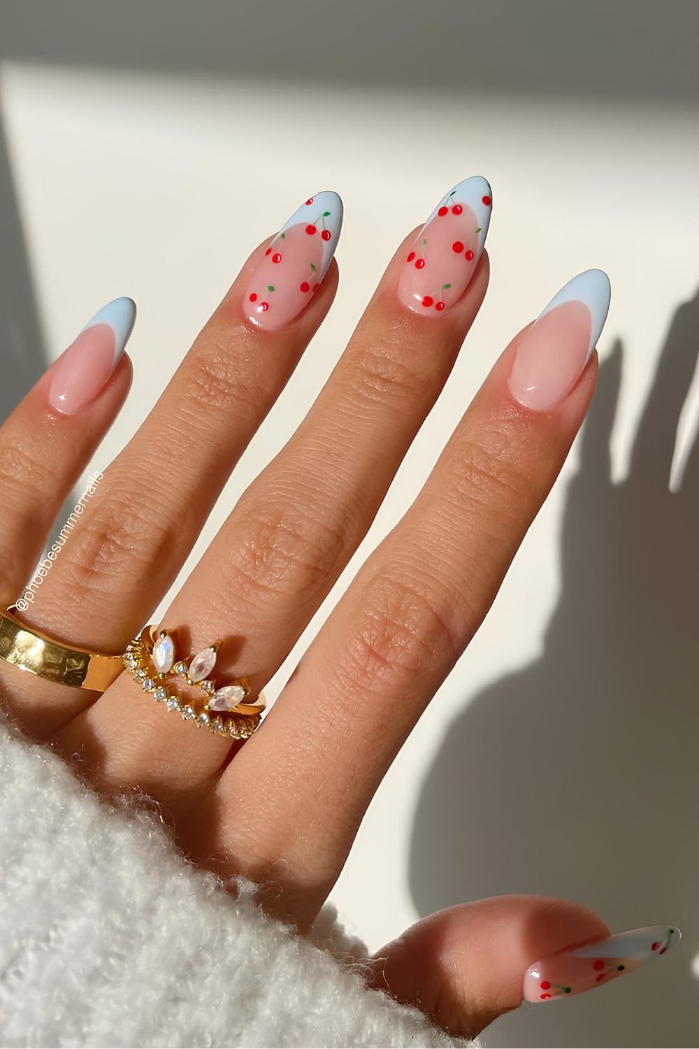 Light blue French nails with cherry accents