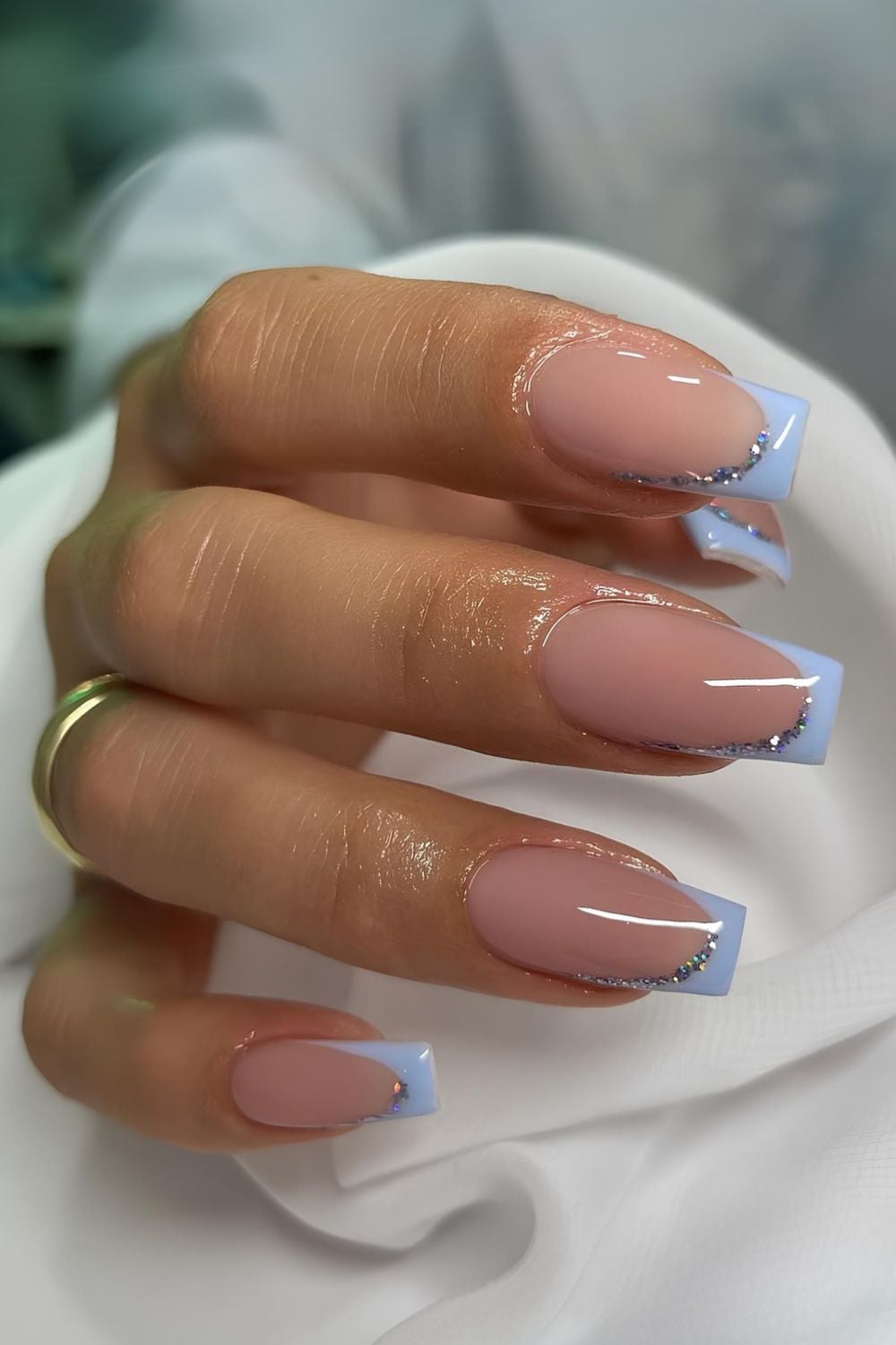 Light blue French nails with glitter