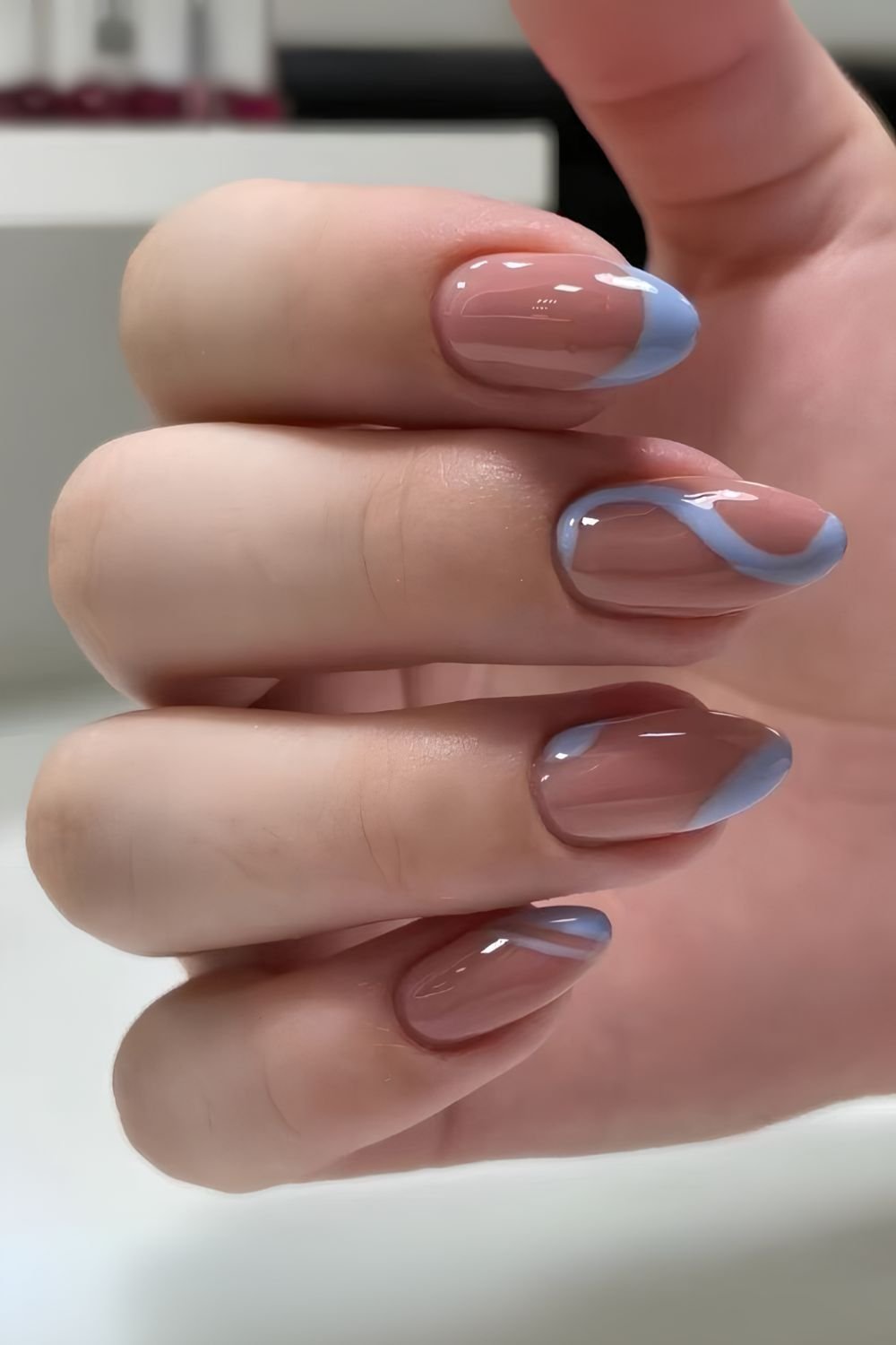 Light blue French nails with swirl accent