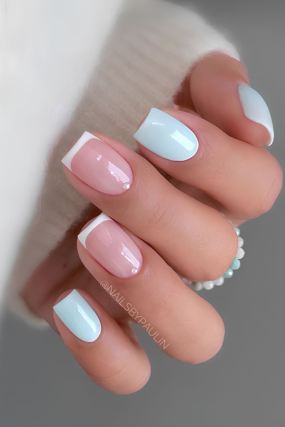 Light blue and white french nails with pearl accents