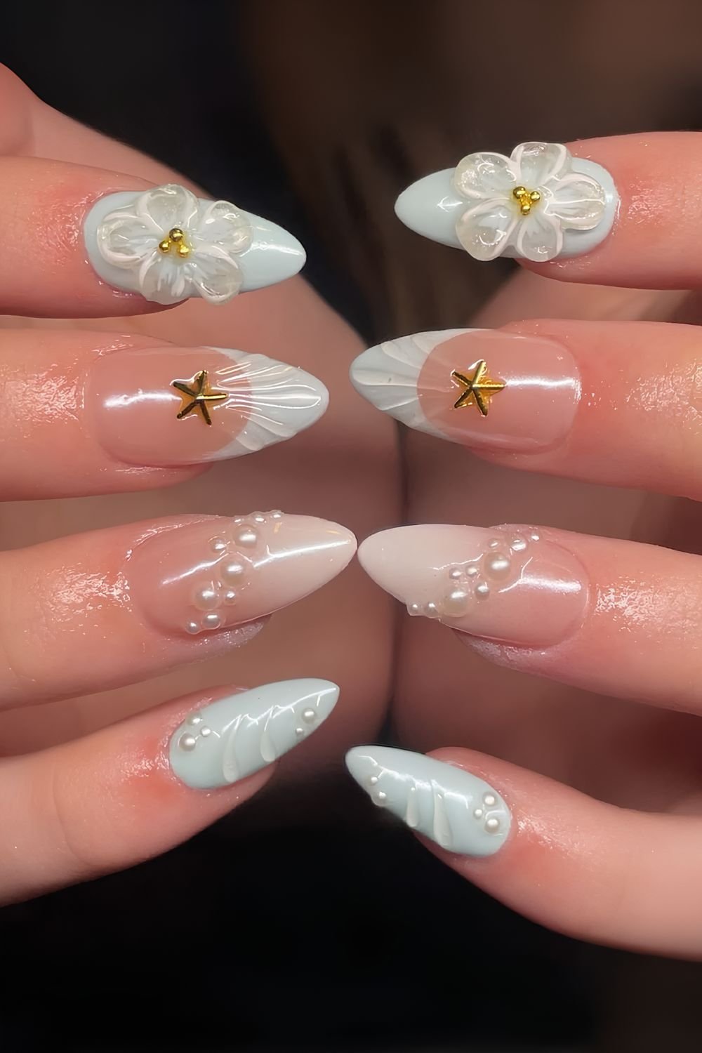 Light blue and white ombre nails with sculpted flowers, pearls and starfish details