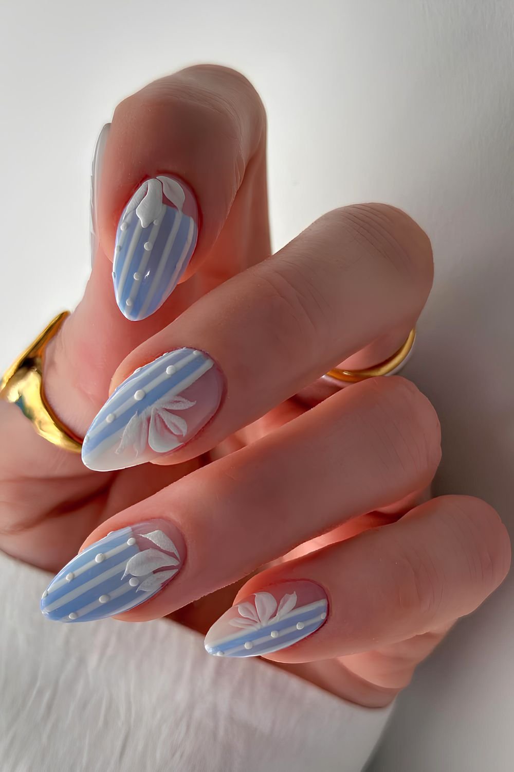 Light blue and white stripes nails with dot and floral details