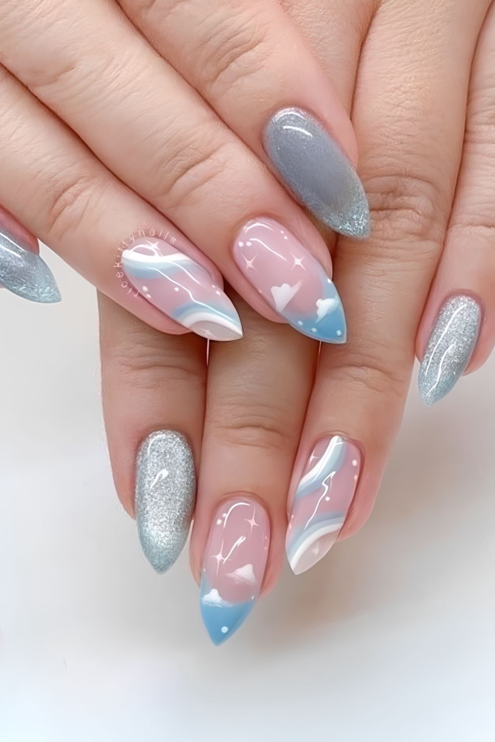 Light blue cat eye and neutral nails with sky inspired details