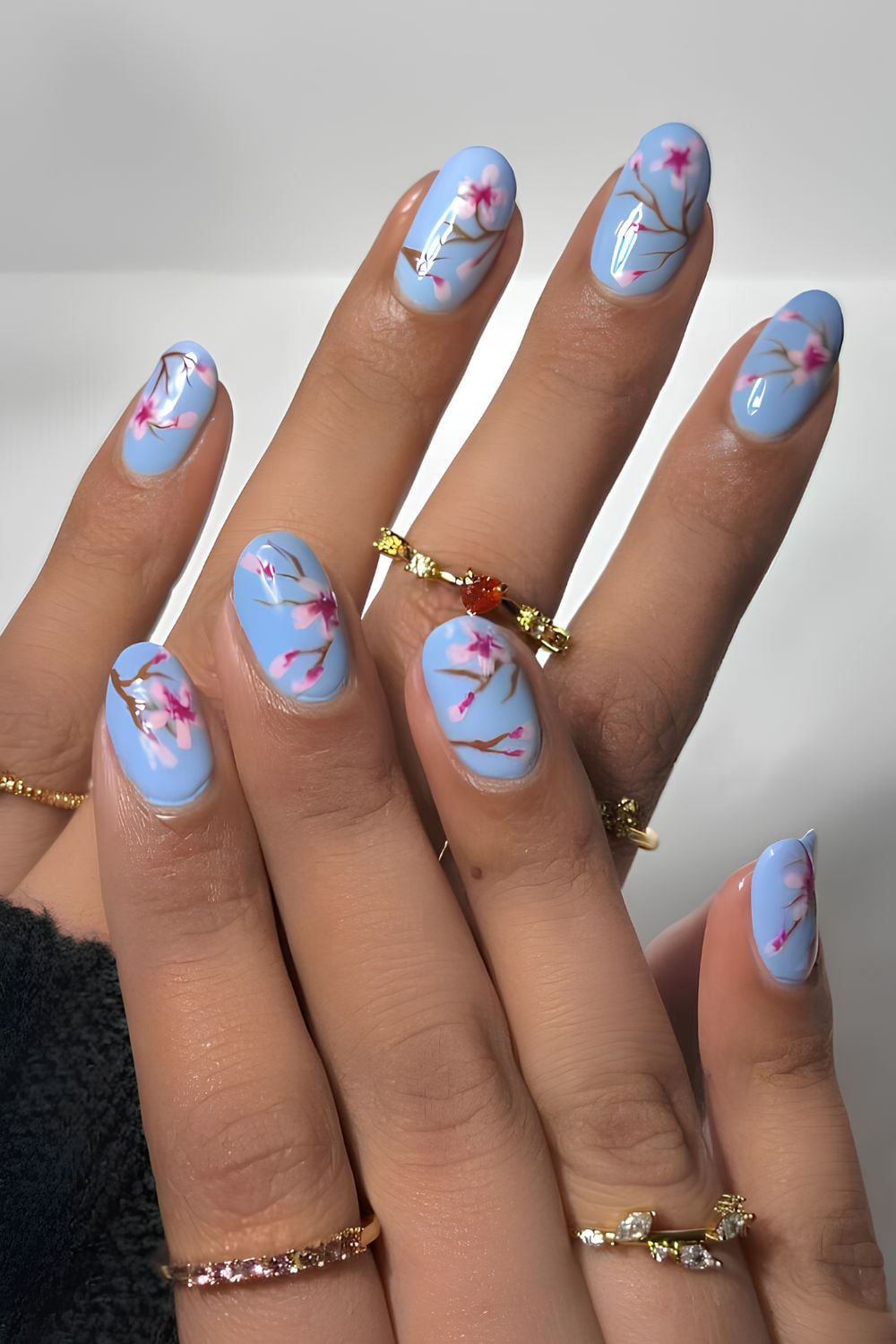 Light blue nails with cherry blossoms