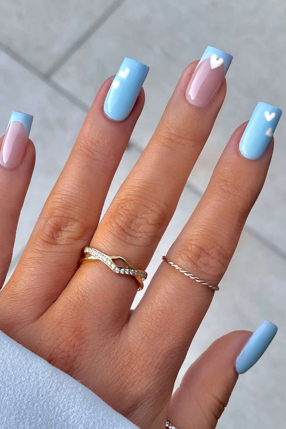 Light blue nails with white hearts