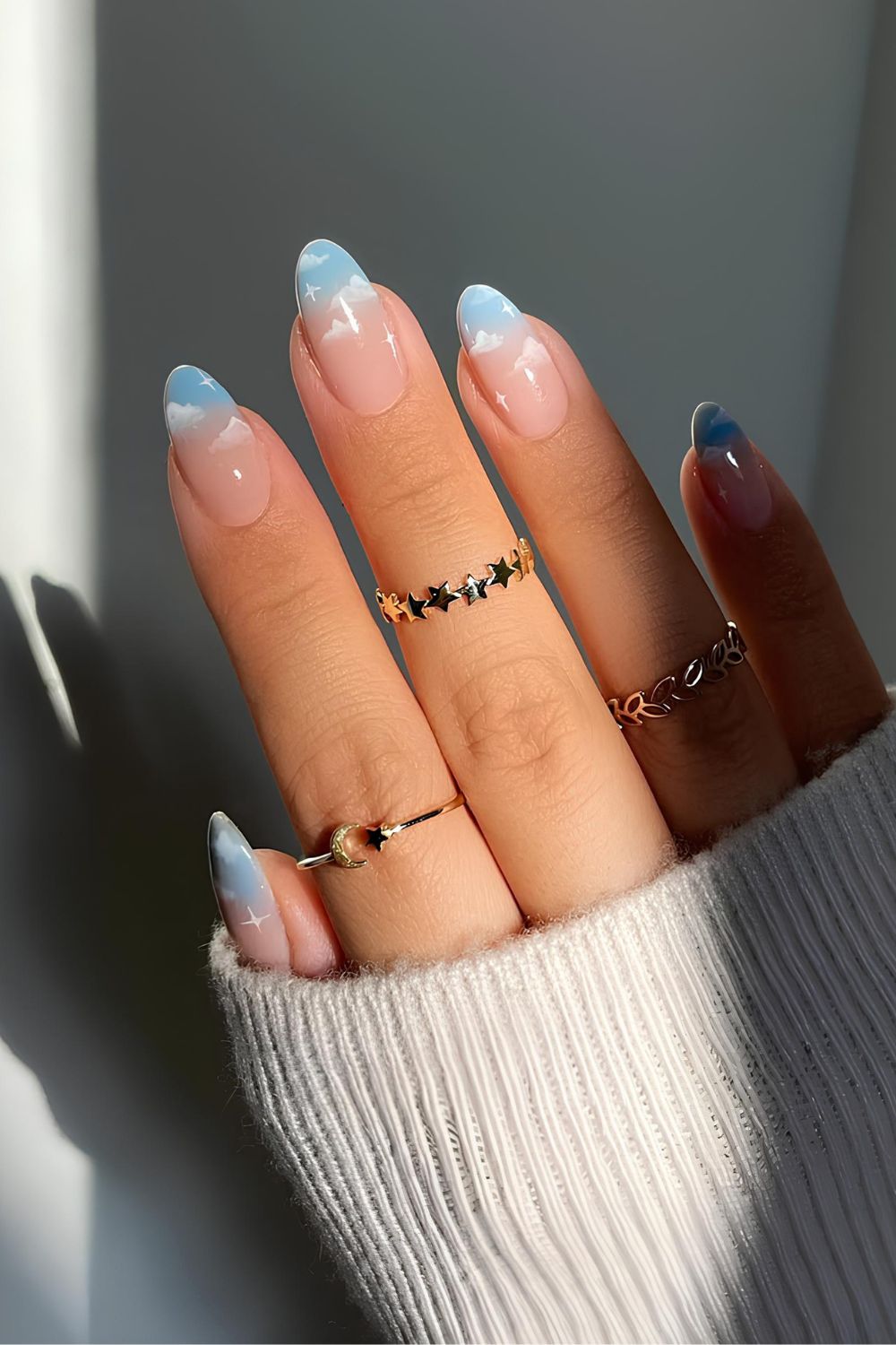 Light blue ombre French nails with cloud accents
