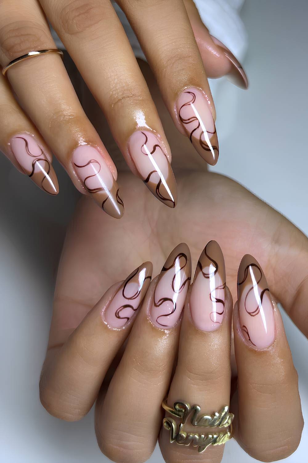 Light brown French nails with swirl art