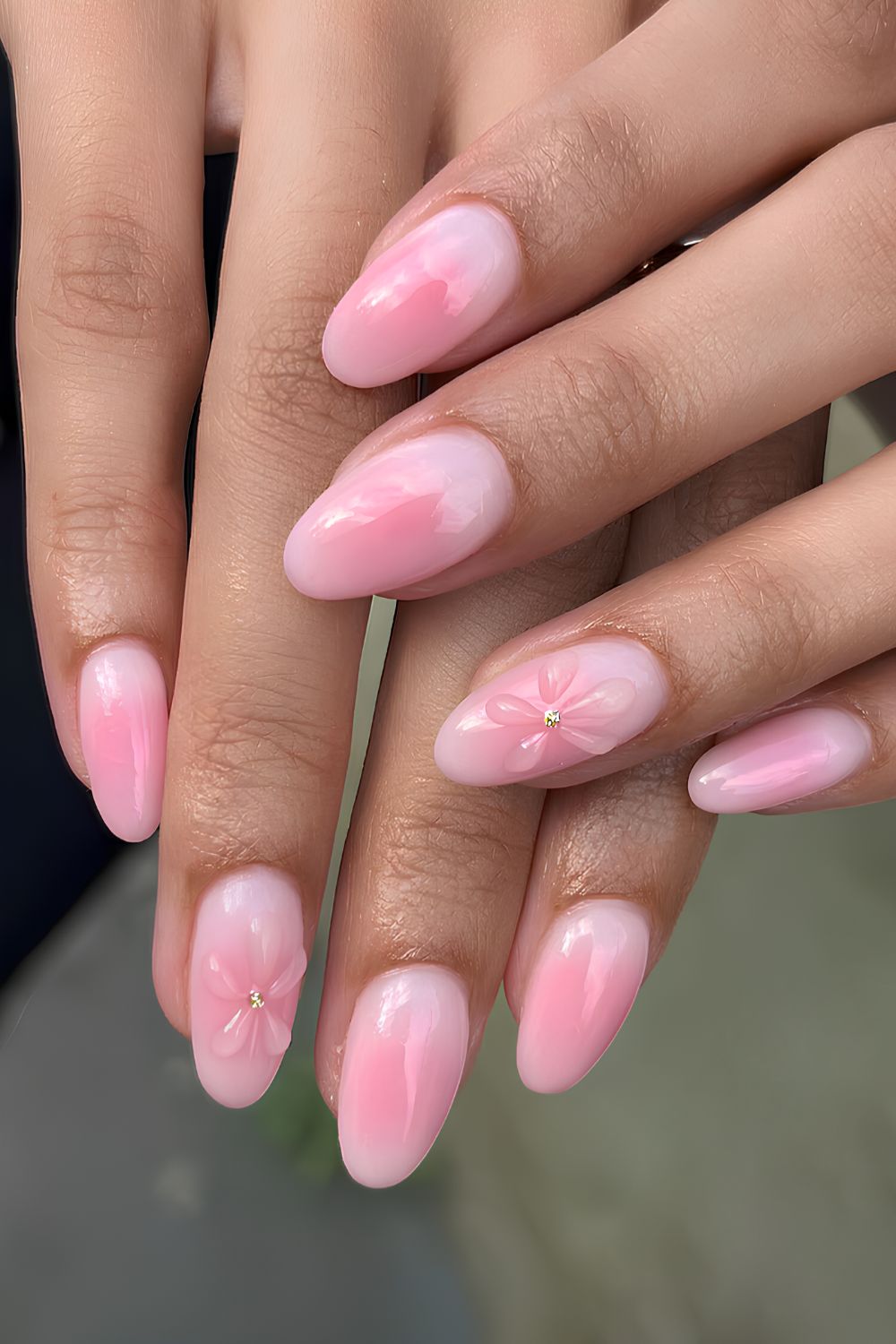 Light pink aura nails with textured flowers