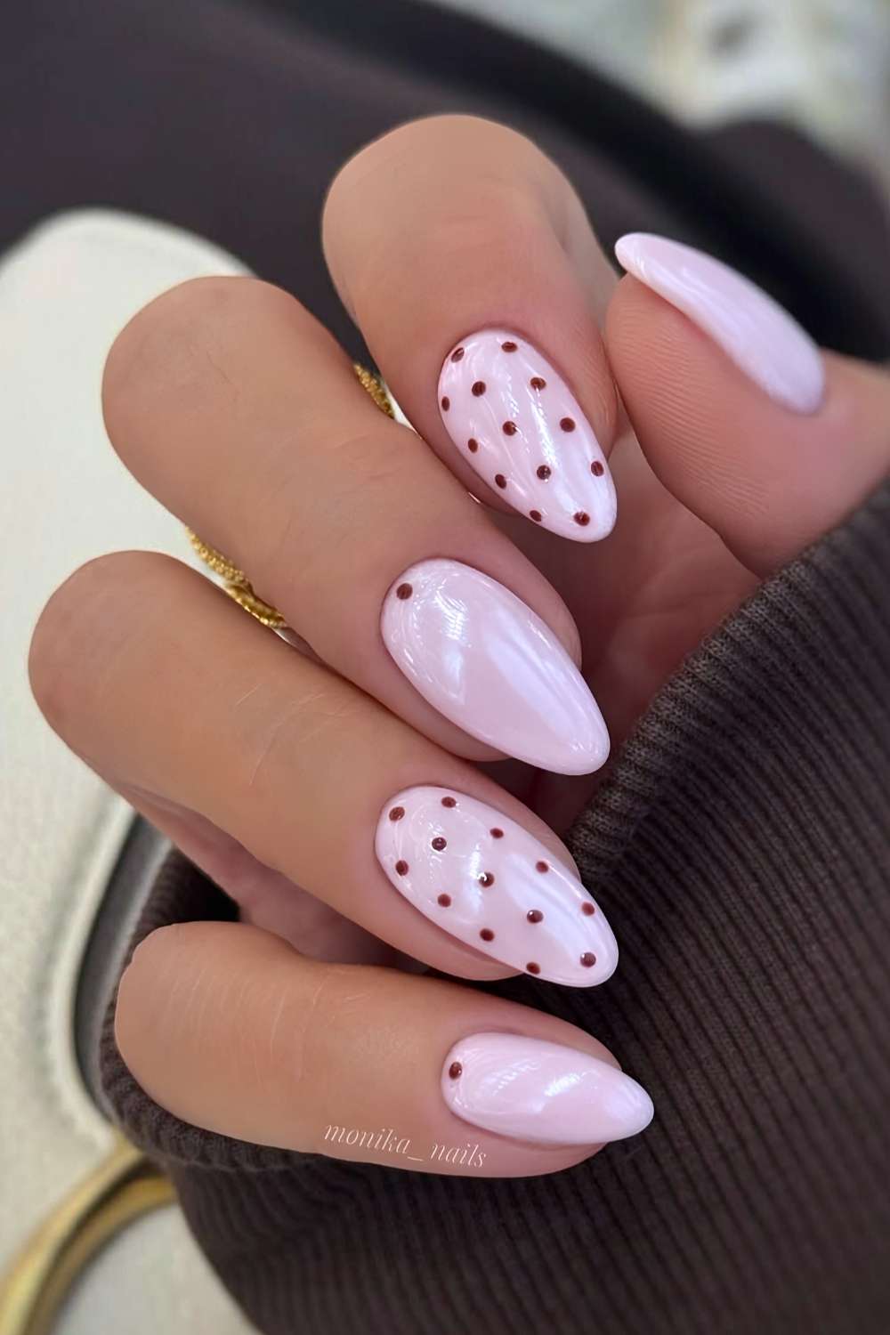Light pink nails with brown polka dots