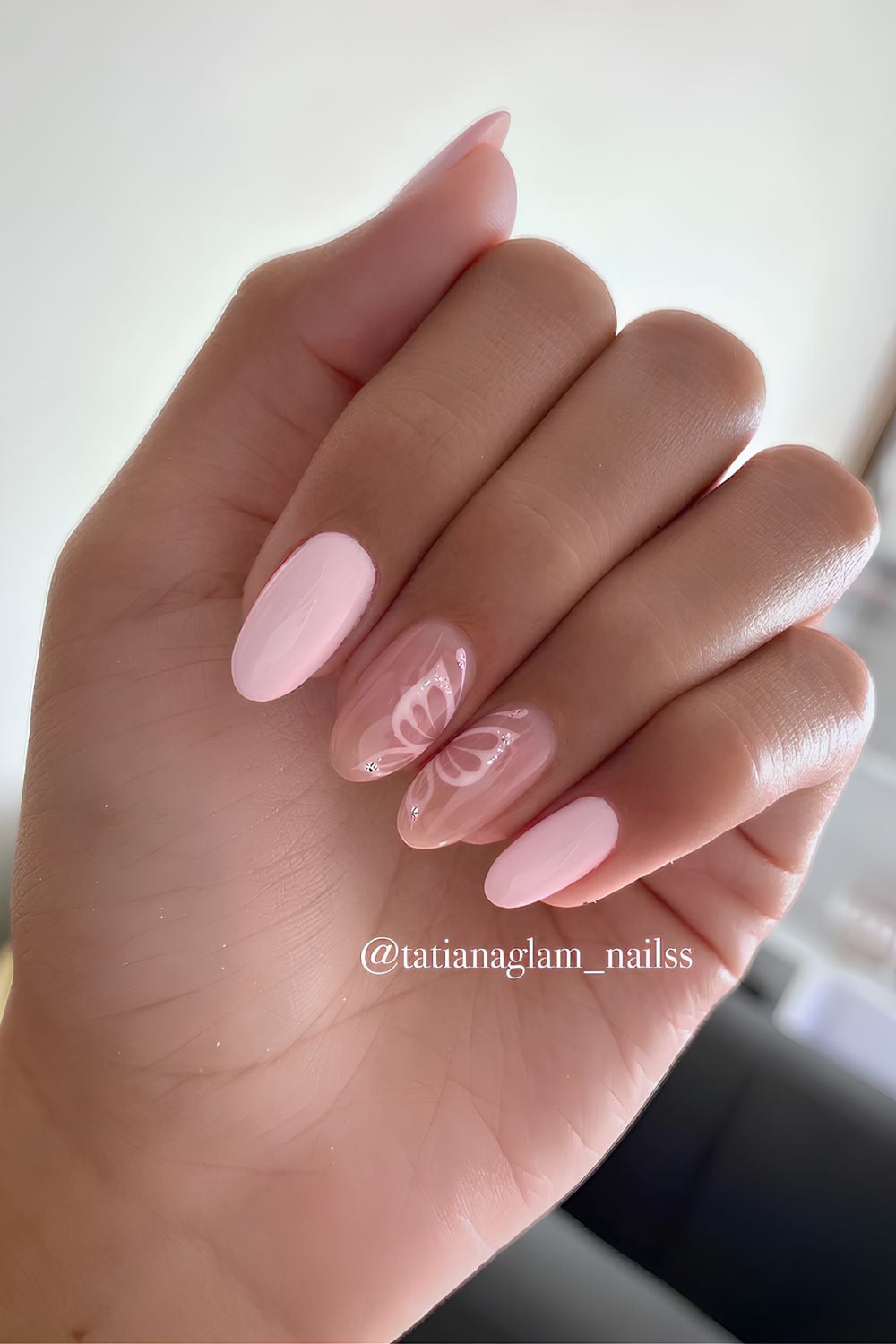 Light pink nails with butterfly art