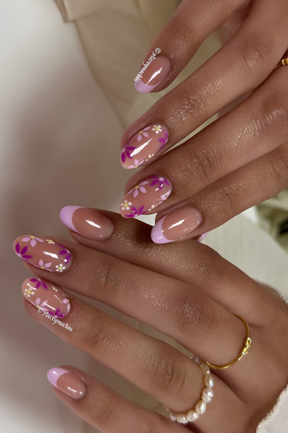 Lilac french tips and neutrals with floral accents in purple tones