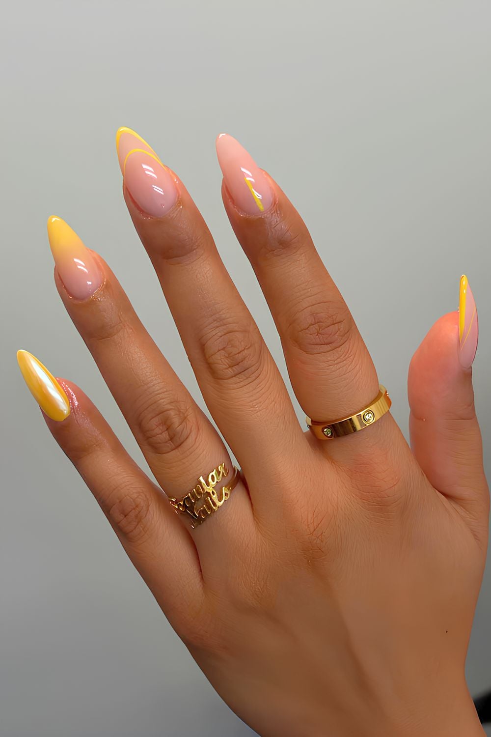 Marigold yellow and neutral nails with multiple designs