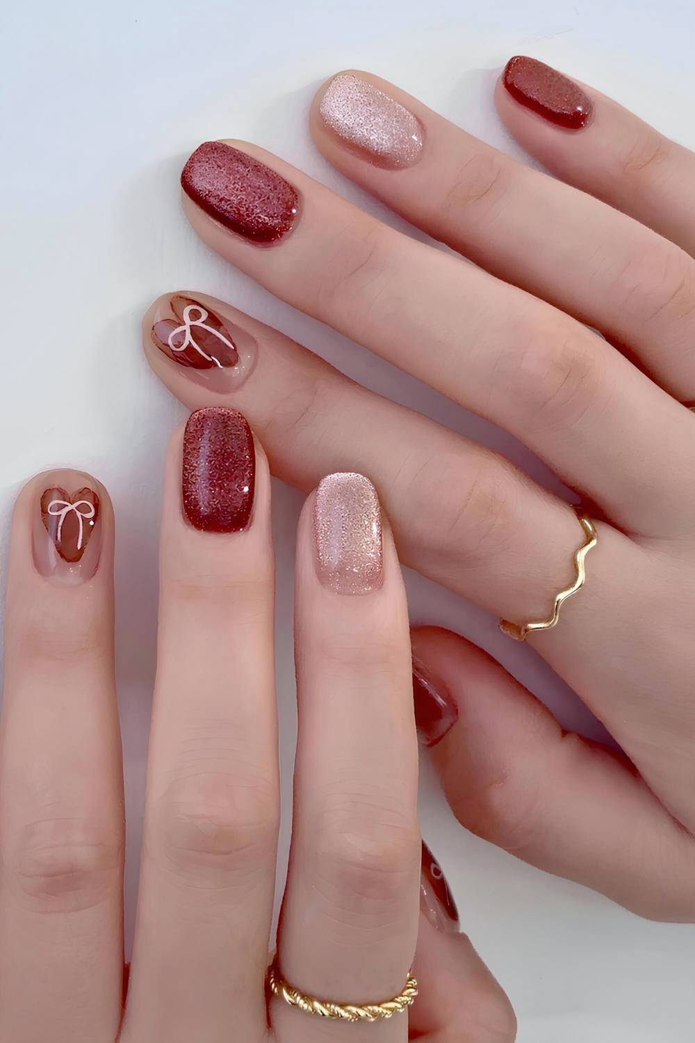 Maroon and gold velvet nails with bows
