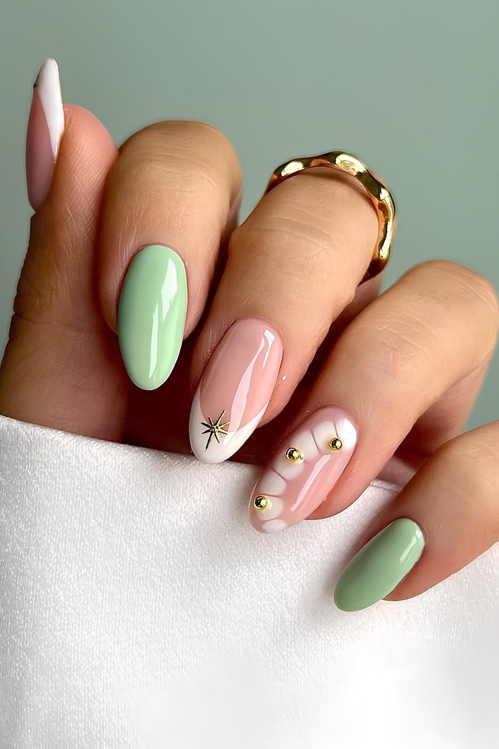 Matcha green and white nails with gold pearls and star accents
