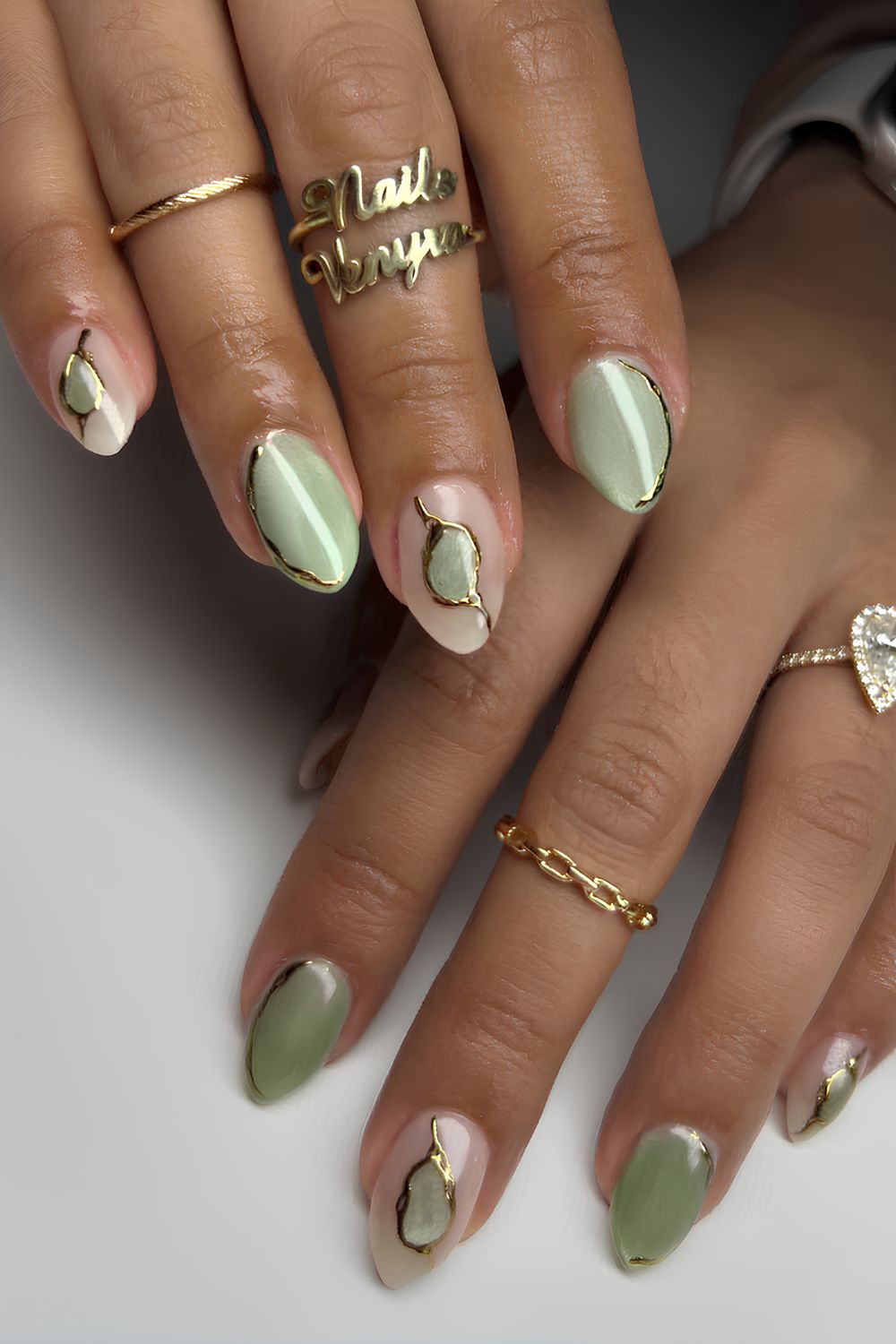 Matcha green cat eye nails with gold details