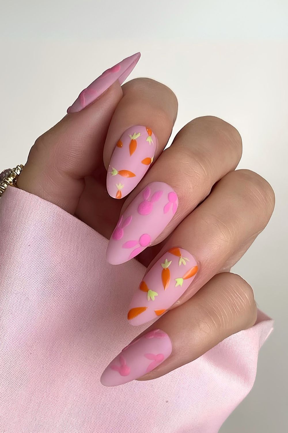 Matte pink nails with carrots and pink bunnies