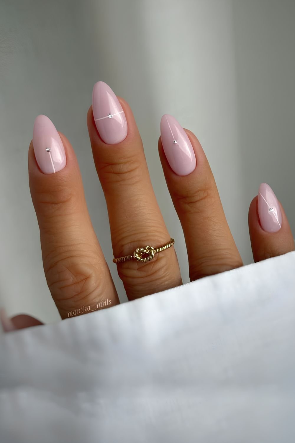 Milky baby pink nails with tiny gems and subtle white lines
