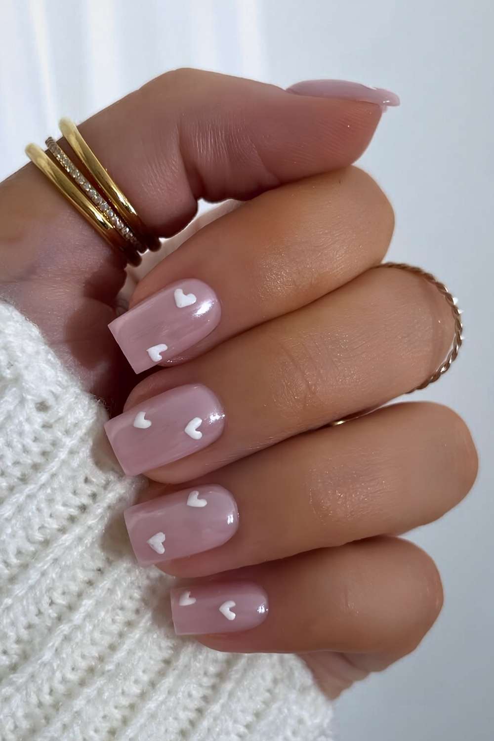 Milky chrome nails with white hearts