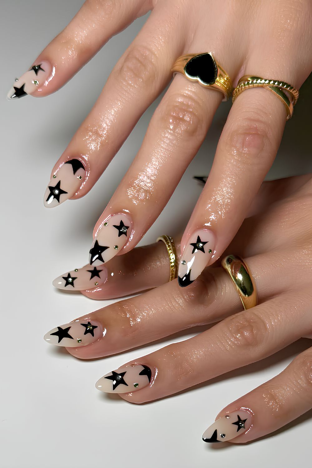 Milky nails with black stars and gems