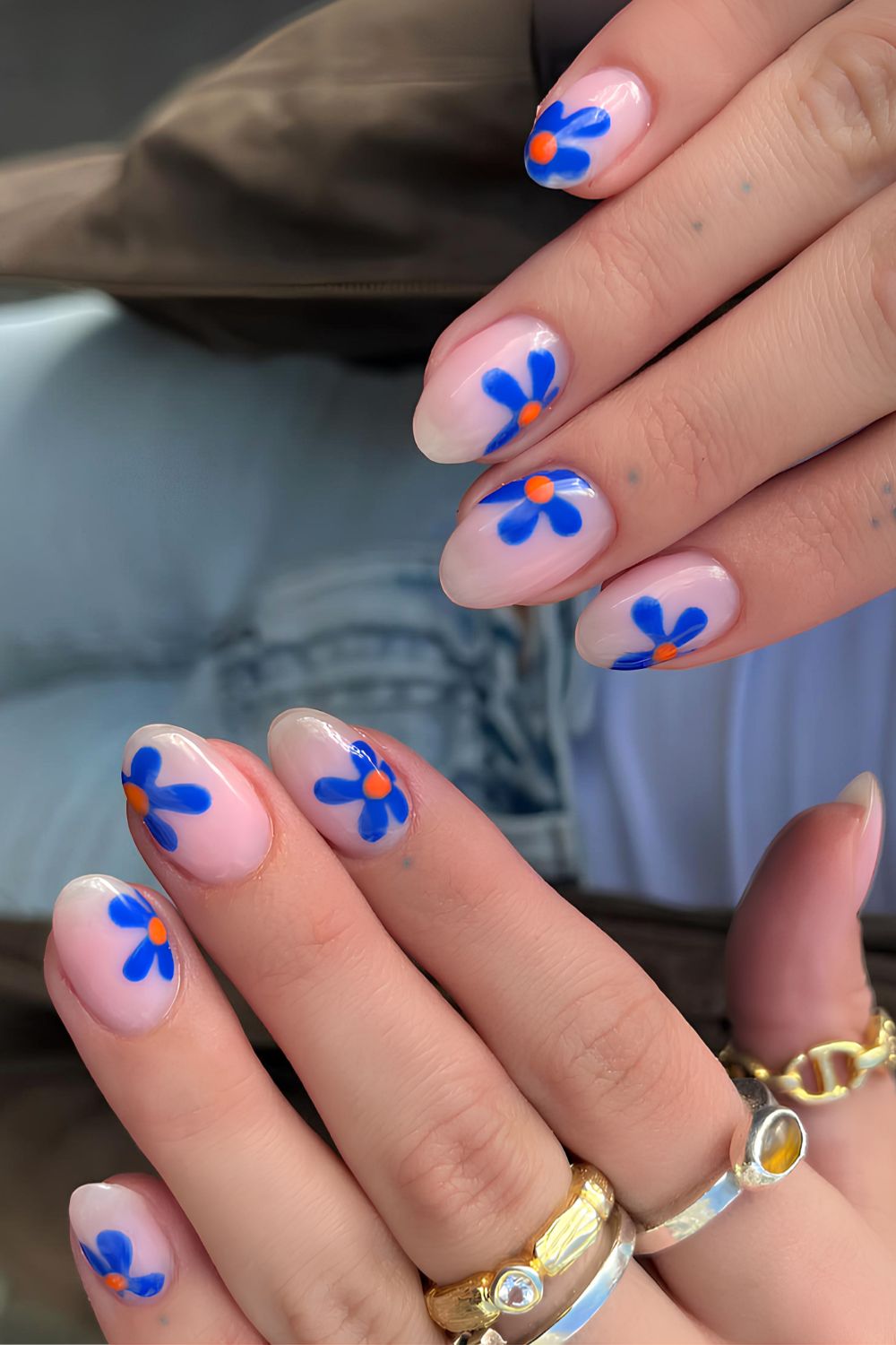 Milky nails with blue and orange floral art